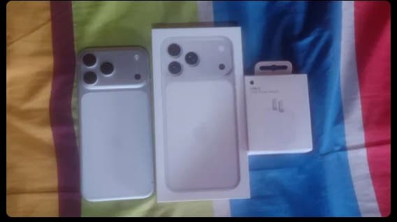 A boxed iPhone 17 Pro Max on a bed